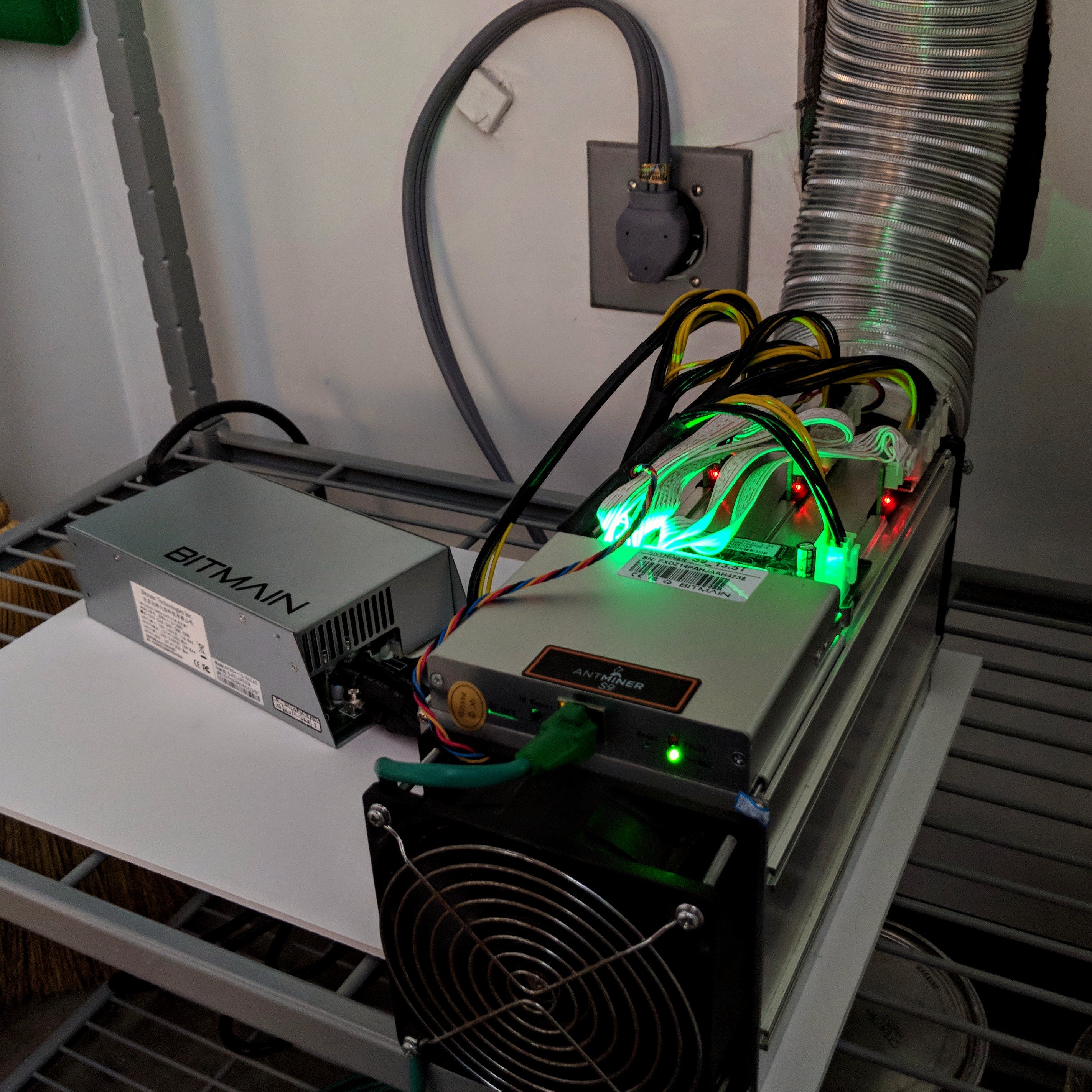 Antminer S9 with a separate Bitmain power supply and ventilation duct, photographed in 2018