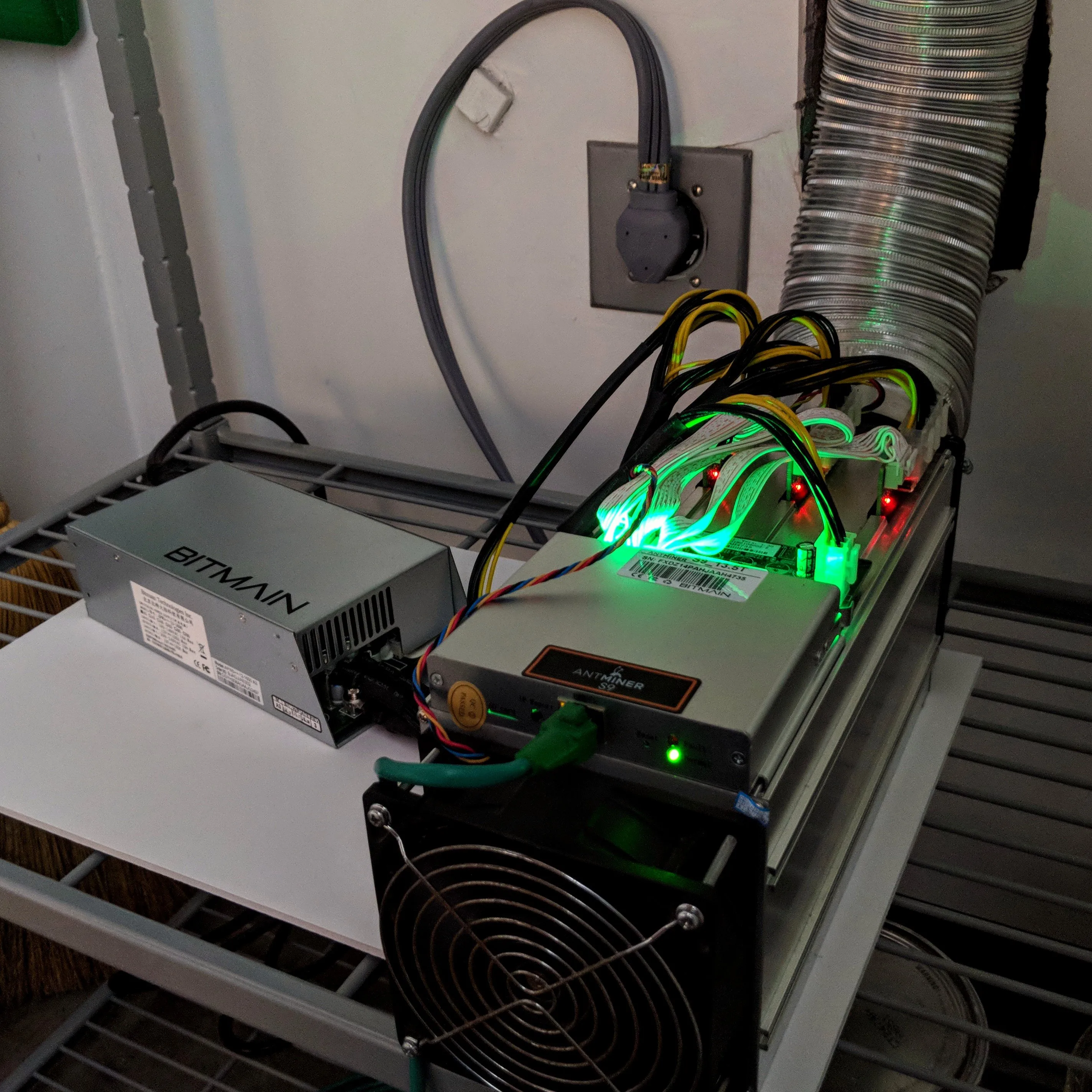 Antminer S9 with a separate Bitmain power supply and ventilation duct, photographed in 2018